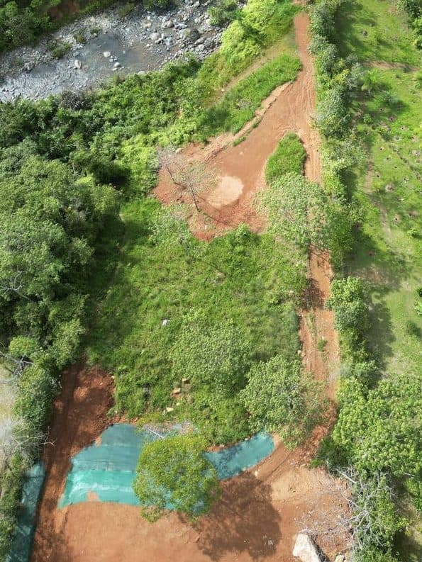 Drone view: river frontage, building pads and access road